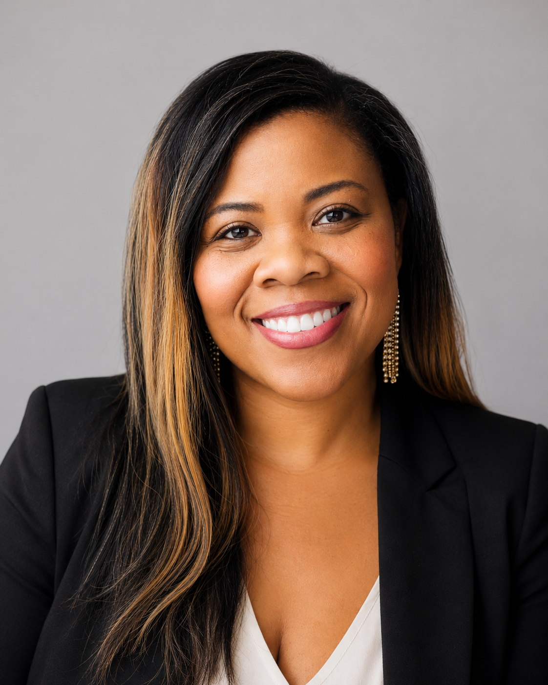 Confident professional woman in business attire smiling in an office.